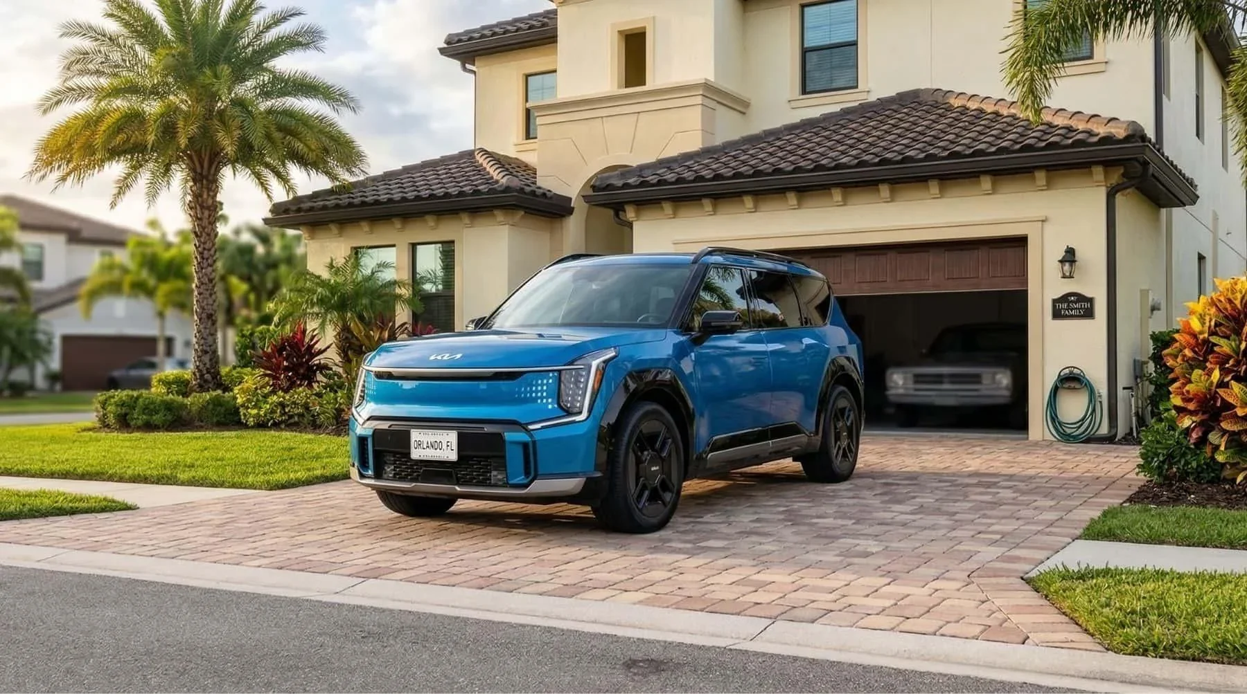 A blue Kia SUV parked on the driveway of a house.