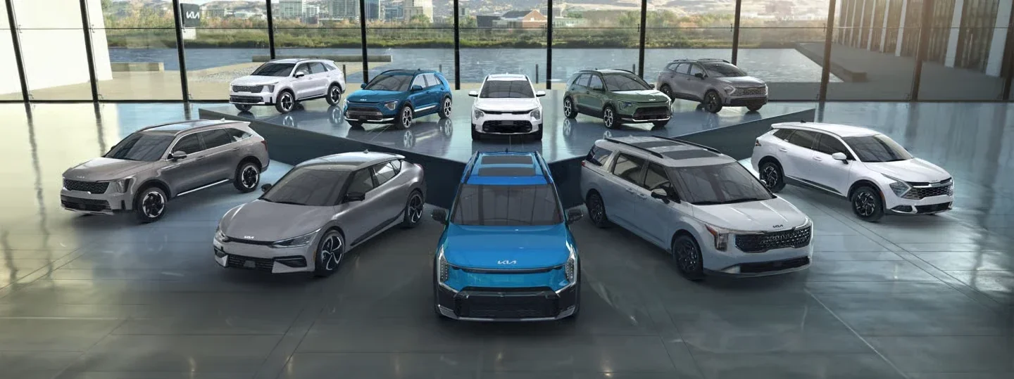 The Kia lineup parked together on a raised platform.