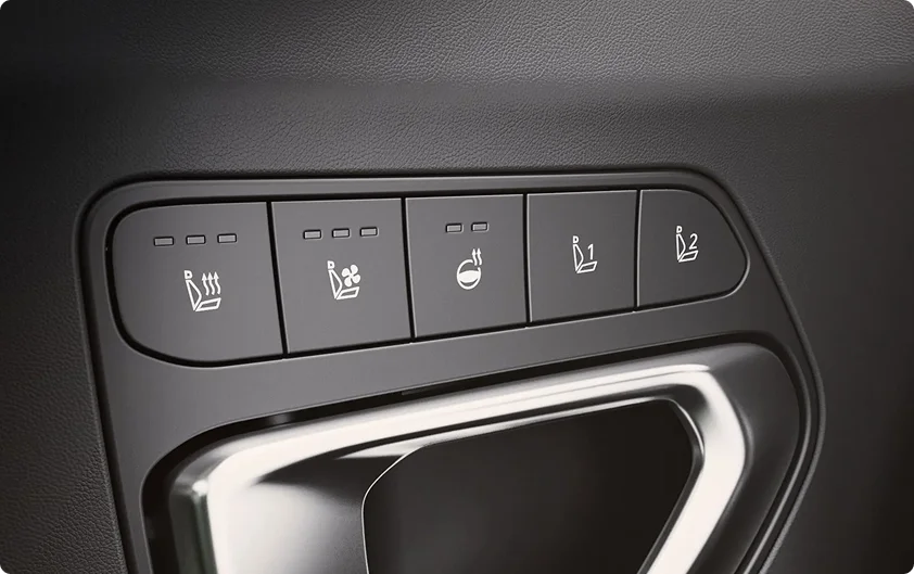 Close-up of the 2026 Kia K4 center console buttons for the heated and ventilated front seats