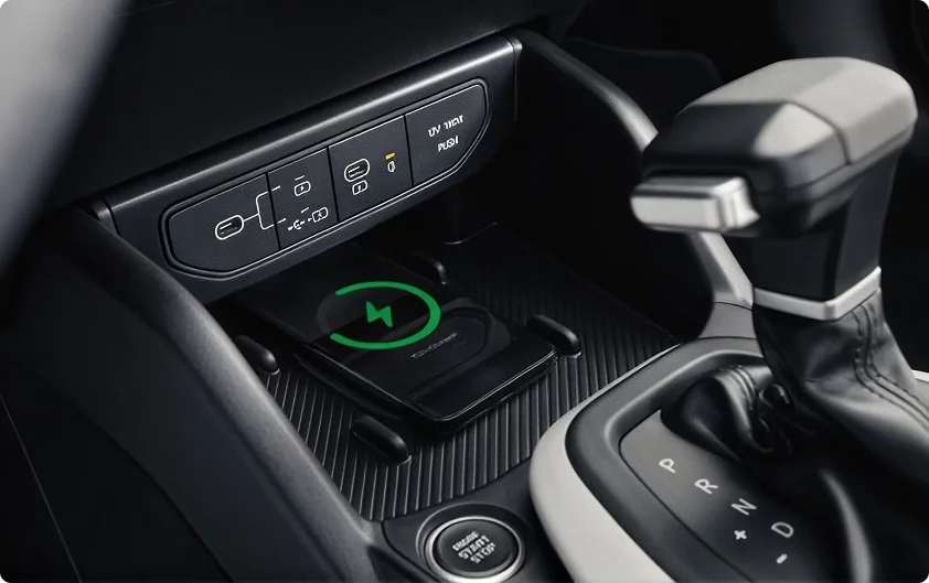 2026 Kia K4 center console showing the wireless charging pad lit green alongside USB-C ports and the gear selector