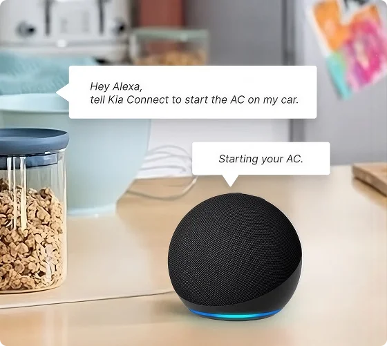 Amazon Echo Dot smart speaker on a kitchen counter with speech bubbles asking Kia Connect to start the car's air conditioning