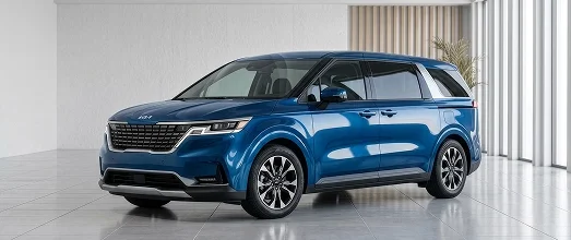 Blue Kia Carnival minivan shown from the front three-quarter view in a bright showroom