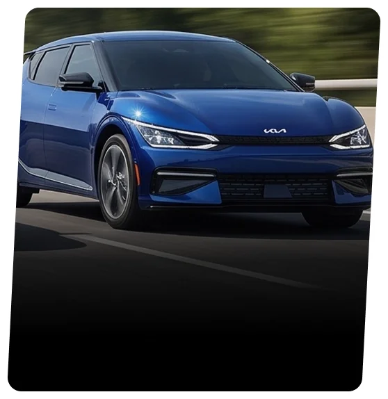 Blue Kia EV6 electric crossover shown from the front three-quarter view on an open road