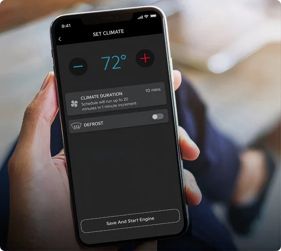 Hand holding a smartphone showing the Kia Access app Set Climate screen at 72 degrees