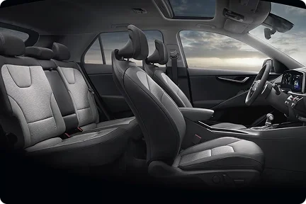 2026 Kia Niro Hybrid cabin seen in profile with the front and rear seats in two-tone gray upholstery