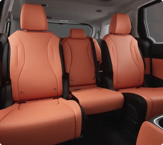 Carnival MPV second and third-row seating in orange leather with the middle Slide-Flex seat in place