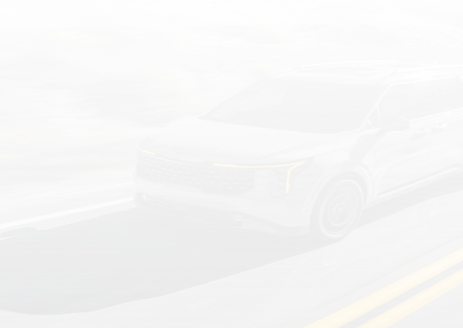 Faint watermark of a Carnival MPV Hybrid driving on a mountain road, behind the gallery grid
