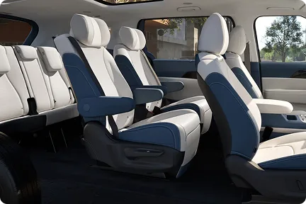 Carnival MPV Hybrid cabin showing all three rows in cream and navy leather