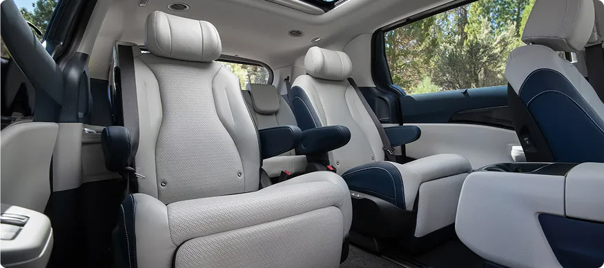 Carnival MPV Hybrid second-row captain's chairs seen from the sliding-door side