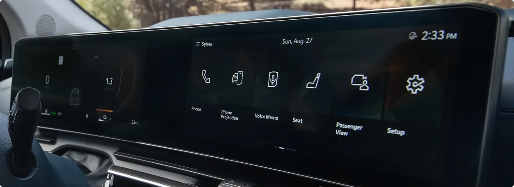 Carnival MPV panoramic display showing the home menu of vehicle feature icons