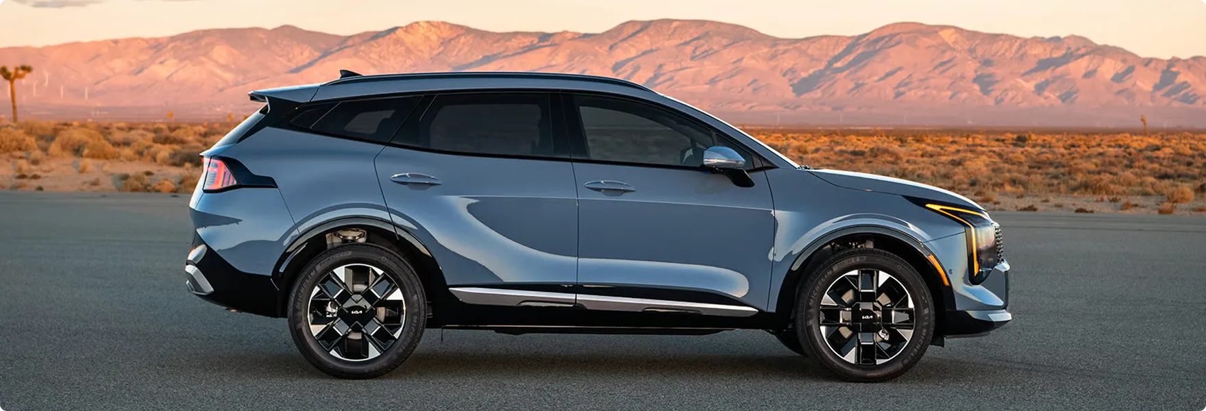 Grey 2027 Kia Sportage driving on a highway