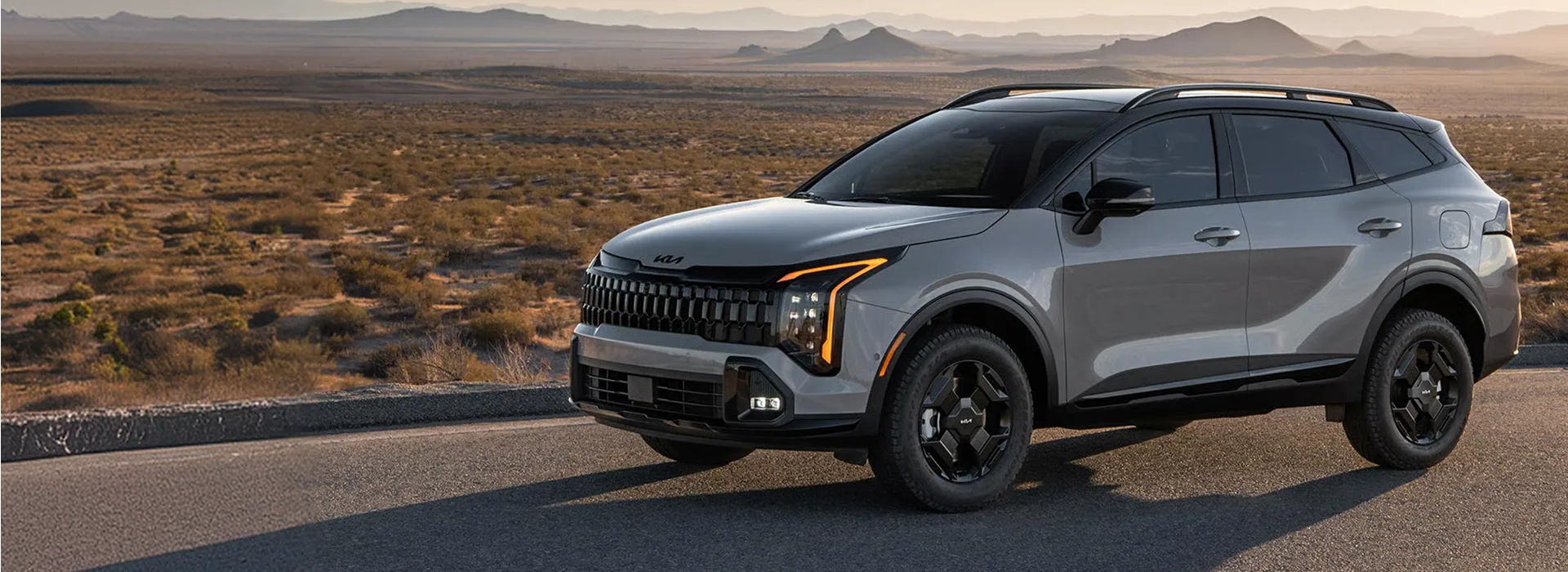 Grey 2027 Kia Sportage on a mountain road