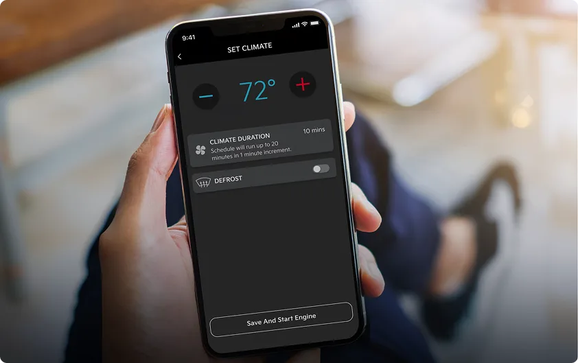 Hand using a smartphone to remote start a Kia Sportage
