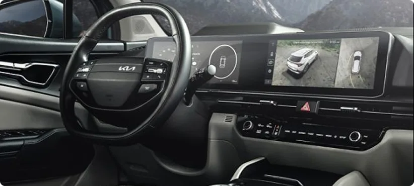 Sportage Hybrid Dual Panoramic Display seen over the steering wheel, the right screen showing a parking camera view