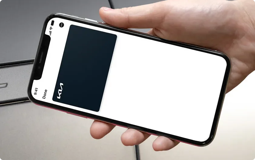 Hand holding a smartphone acting as a Digital Key 2.0 against the vehicle door