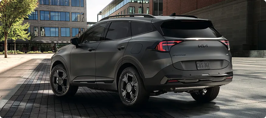 Sportage Plug-in Hybrid rear three-quarter view in a city plaza