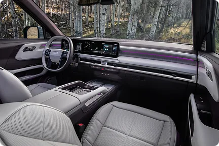 Telluride Hybrid front cabin in light leather with purple ambient lighting and woodland outside