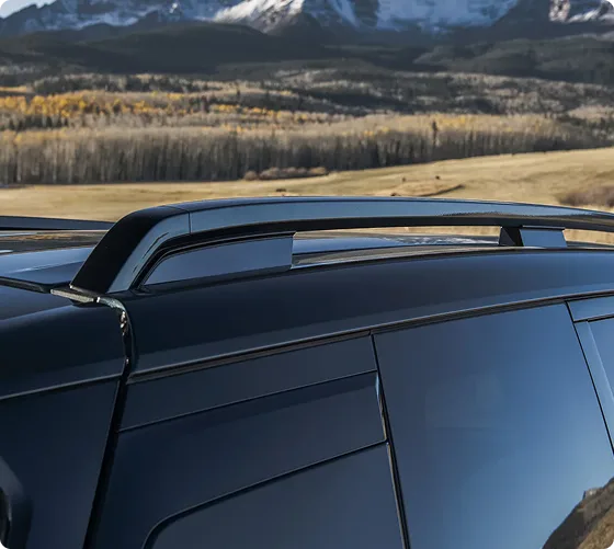 Close-up of the Telluride Hybrid raised roof rails above open grassland