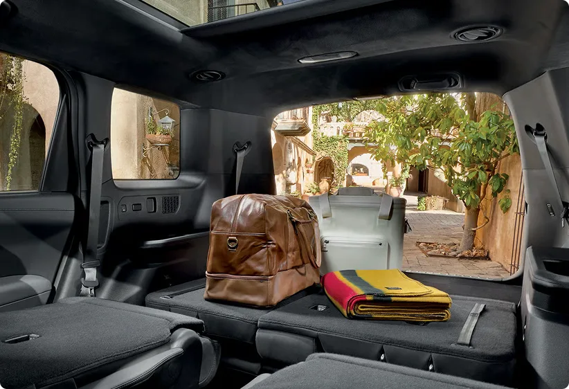 Open Telluride Hybrid cargo area loaded with bags, rear seats folded flat