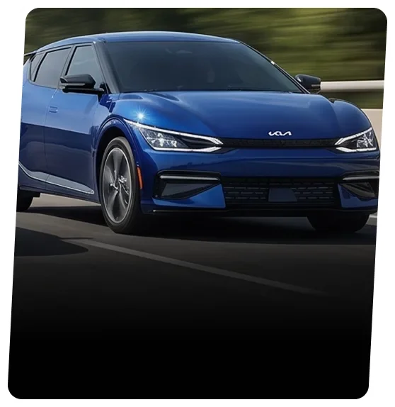 Blue Kia EV6 electric crossover driving on a highway