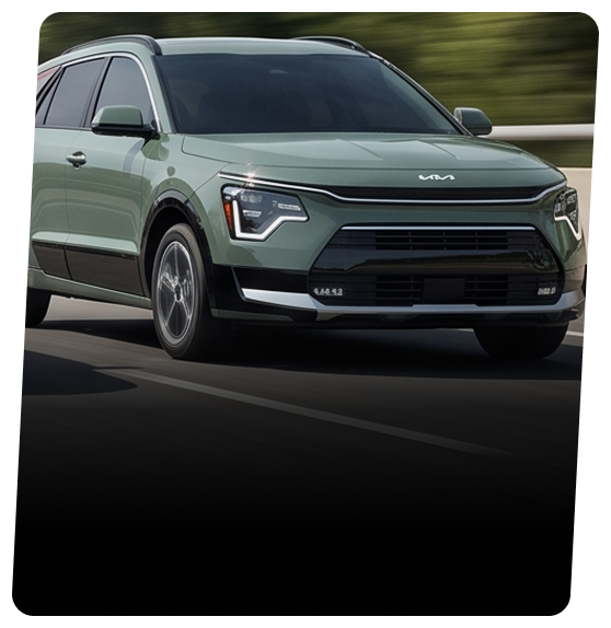 Green Kia Niro hybrid crossover on a city street