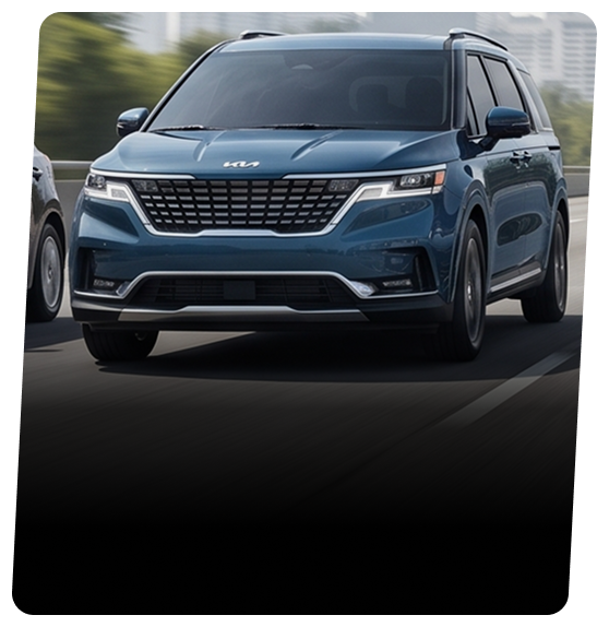 Blue Kia Carnival minivan on a city street