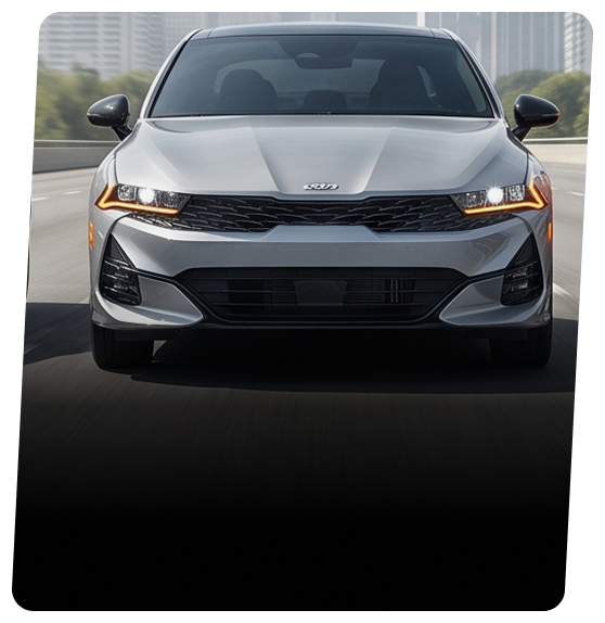 Silver Kia sedan driving on a city road