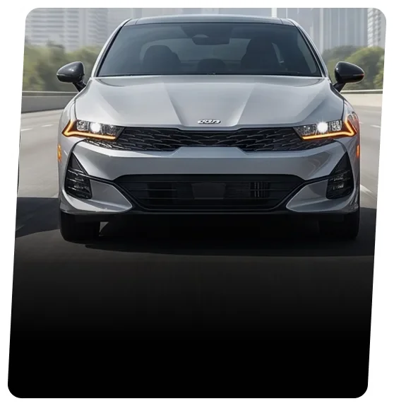 Silver Kia sedan driving on a city road