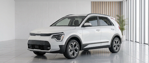 White Kia hybrid crossover in a bright studio showroom