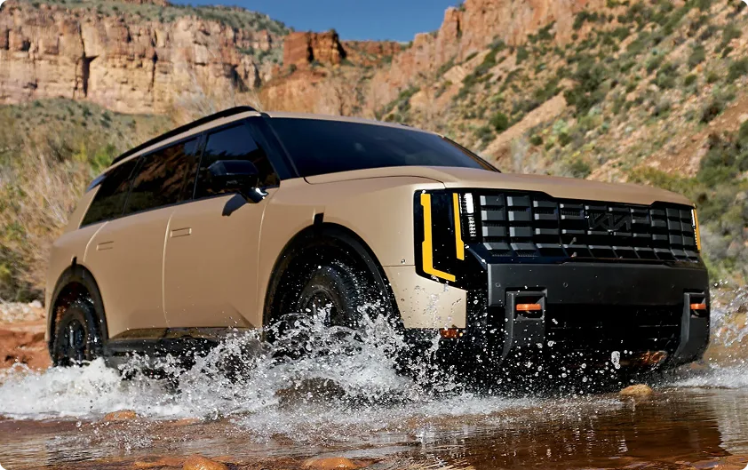 Bronze Telluride X-Pro driving through shallow water in a canyon