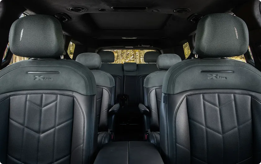 Telluride X-Pro embossed front seats in dark leather, seen from the rear cabin